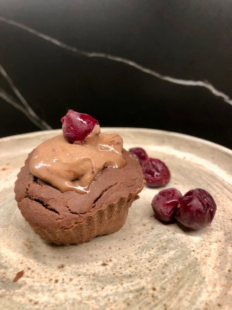 gluten-free chocolate muffin with cacao cream and cherries