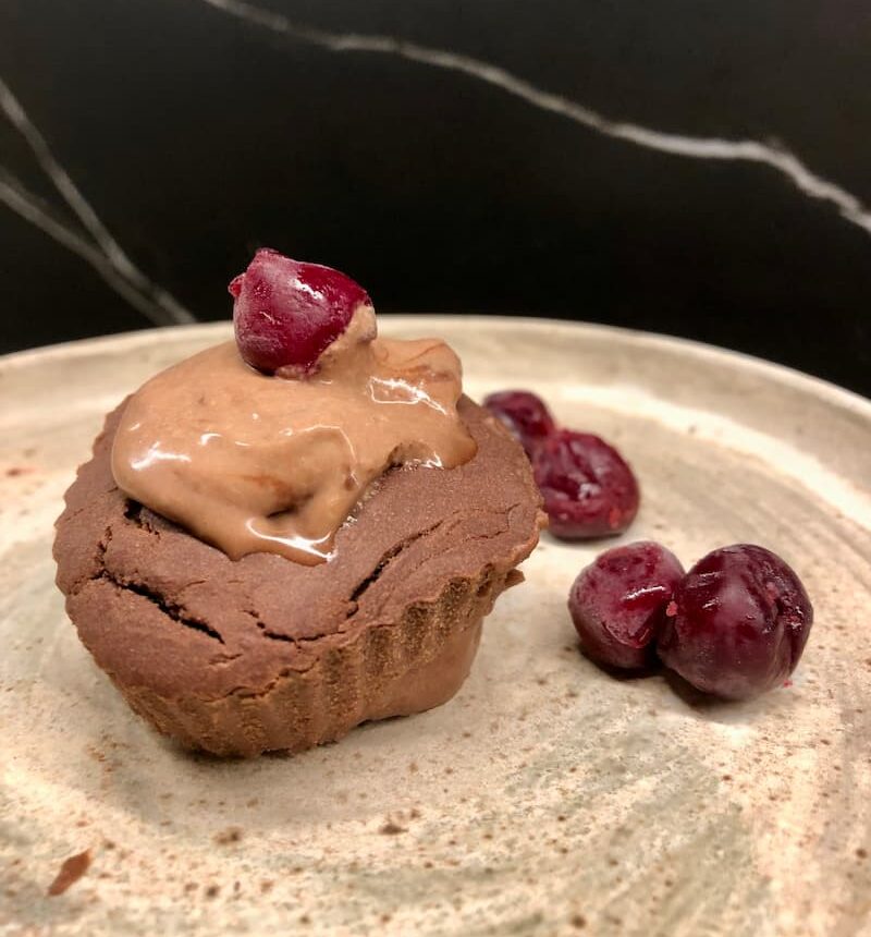 gluten-free chocolate muffin with cacao cream and cherries