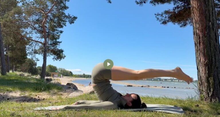 pilates roll over exercise at the beach