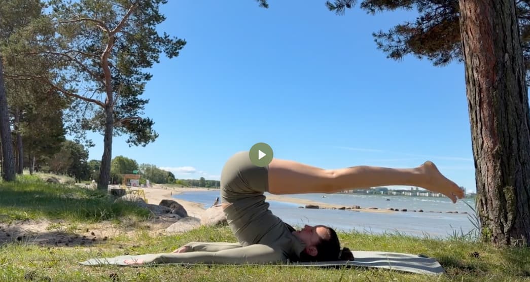 pilates roll over exercise at the beach